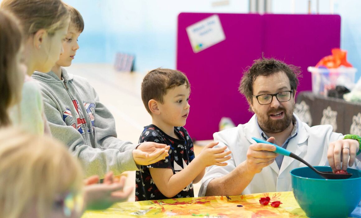Child doing science experiments at Kids Camp Holiday Activities