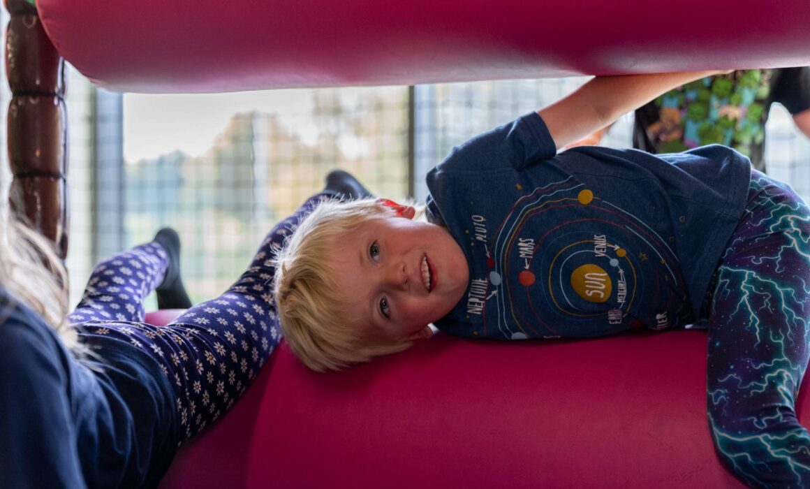 child playing in soft play area