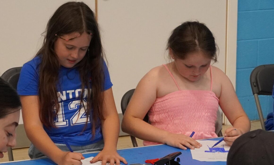 two girls sat colouring in